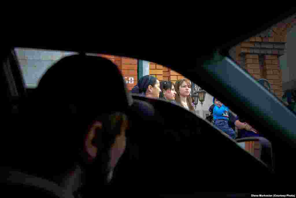 A Chechen boy checks out girls from behind black-tinted windows. 