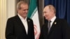 Russian President Vladimir Putin (right) greets Iranian President Masud Pezeshkian during a meeting on the sidelines of the Shanghai Cooperation Organization summit in Tianjin, China, in September 2025.