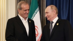 Russian President Vladimir Putin (right) greets Iranian President Masud Pezeshkian during a meeting on the sidelines of the Shanghai Cooperation Organization summit in Tianjin, China, in September 2025.