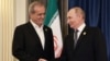 Russian President Vladimir Putin (right) shakes hands with Iran's President Masud Pezeshkian on the sidelines of the Shanghai Cooperation Organization summit in China on September 1.