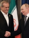 Russian President Vladimir Putin (right) shakes hands with Iran's President Masud Pezeshkian on the sidelines of the Shanghai Cooperation Organization summit in China on September 1.