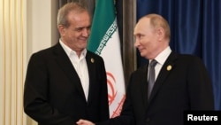 Russian President Vladimir Putin (right) shakes hands with Iran's President Masud Pezeshkian on the sidelines of the Shanghai Cooperation Organization summit in China on September 1.