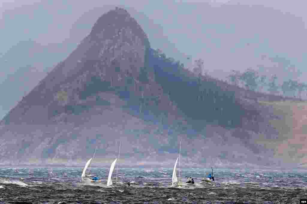 Boats return to port as strong winds forced the cancellation of a race in the men&#39;s 470 class. &nbsp;