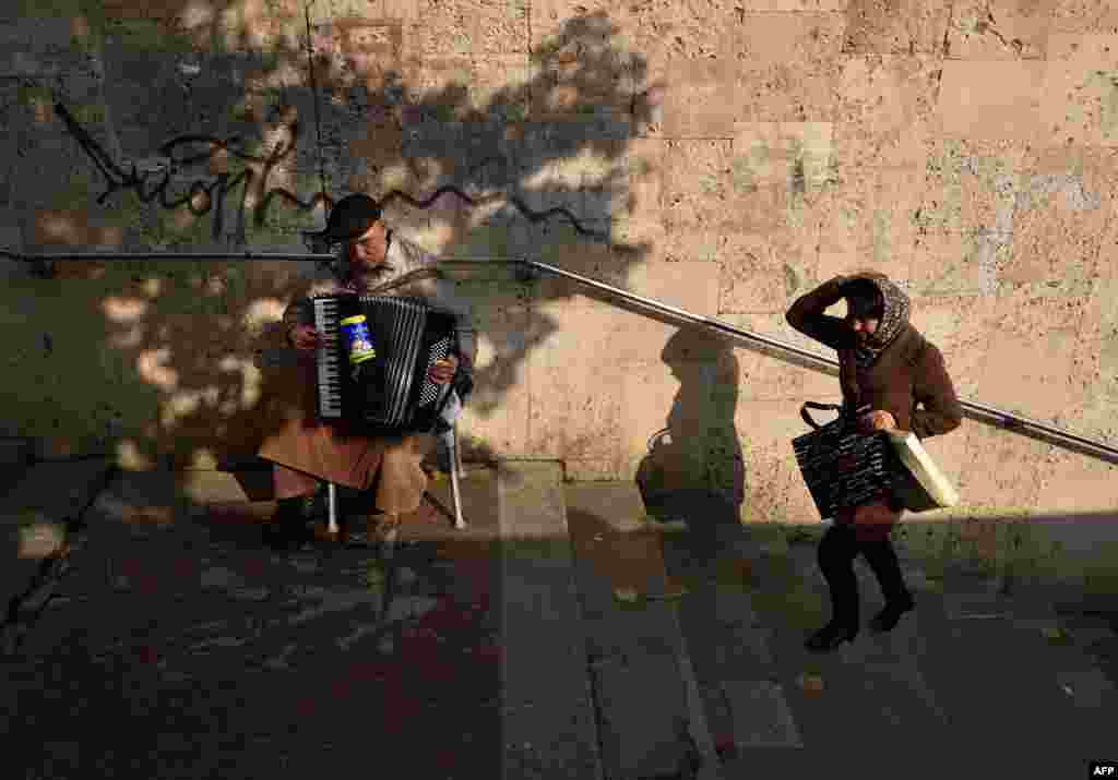 A blind man plays an accordion as he begs for money in the Moldovan capital, Chisinau. (AFP/Daniel Mihailescu)