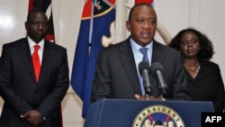 Kenyan President Uhuru Kenyatta speaks during a press conference in Nairobi in front of Kenyan Vice President William Ruto (left) on September 24.