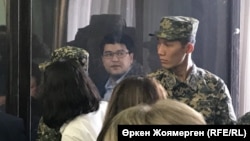 Bishimbaev (in the defendant's cage) at his trial in Astana in 2017