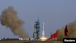 The Long March II-F rocket loaded with the Shenzhou-9 manned spacecraft lifts off from the launch pad at the Jiuquan Satellite Launch Center in Gansu Province on June 16.