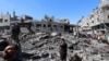 Palestinians inspect the damage after an Israeli strike in the Al-Bureij camp in the central Gaza Strip on July 4, 2025.