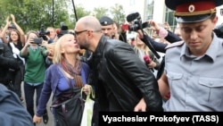 Russian theater director Kirill Serebrennikov (center), who was accused of embezzling state funds and placed under house arrest, is kissed by a supporter after a court hearing in Moscow in September.