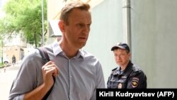 Российский оппозиционер Алексей Навальный, задержанный в ходе митинга 5 мая, направляется в здание суда в Москве, 15 мая 2018 года.