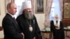 UKRAINE – Russia's president Vladimir Putin (L) awards vice rector of Kiev Pechersk Lavra, Metropolitan Pavel, during a ceremony at Kiev Pechersk Lavra. Right - Patriarch of Moscow Kirill. Kyiv, July 27, 2013