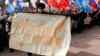 A man holds a map of the Soviet Union during a rally to support Russian-speakers living in Crimea and Ukraine, in the center of the Siberian city of Krasnoyarsk.