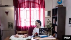 In this now-deleted IRNA photo, Iranian writer Sara Kan'ani is seen glancing at Ahu, a foster child she cared for for 40 days.