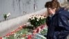 People lay flowers in front of the Polish Embassy in Moscow on April 12.