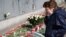 People lay flowers in front of the Polish Embassy in Moscow on April 12.