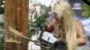 Femen Activists Cut Down Cross In Kyiv