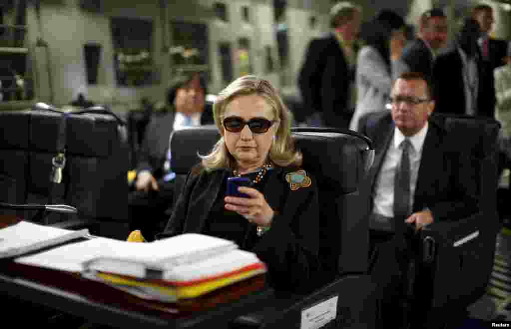 U.S. Secretary of State Hillary Clinton checks messages as she flies to Tripoli, Libya, on a military plane in October 2011. The following year, Libya became the site of a critical challenge in Clinton&#39;s time in office after four Americans were killed in an attack on the U.S. diplomatic mission in Benghazi. Clinton faced criticism over her handling of the attack, although an inquiry found she was not at fault.&nbsp;