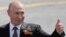 Russian President Vladimir Putin gestures to onlookers following a rescheduled Victory Day parade on Moscow's Red Square on June 24. 