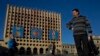 People pass by the Council of Ministers of Abkhazia building in Sukhumi, the capital of the breakaway Georgian region. The building was destroyed in the 1992-93 war with Georgia.