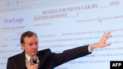 WikiLeaks founder Julian Assange displays a webpage during a press conference in London in October.