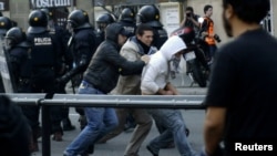 Policemen in plain clothes detain a protester during a general strike in central Barcelona, 29Mar2012