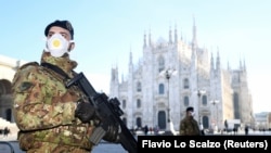 Soldiers wearing face masks stand outside the Duomo cathedral, closed due to the coronavirus outbreak, in Milan, Italy, on February 24.