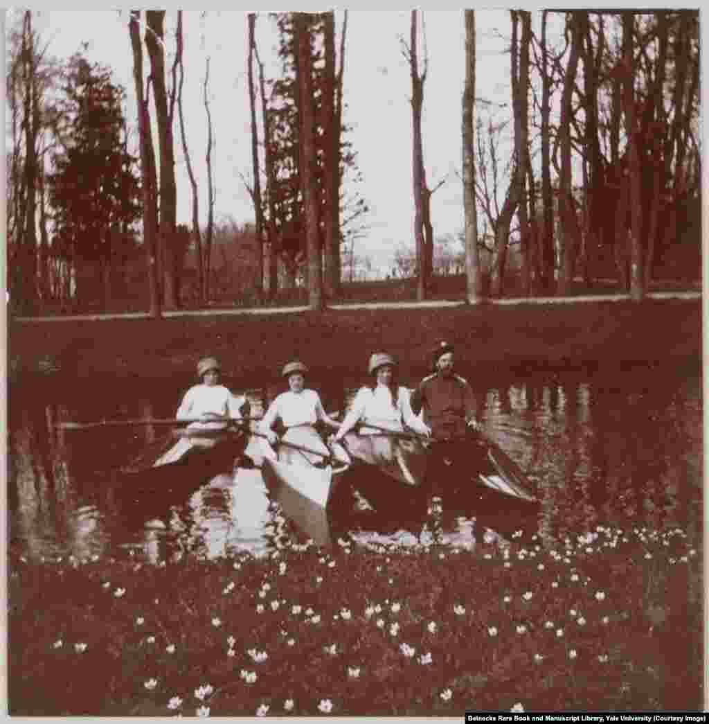 Nicholas II and three of the grand duchesses floating in one of the canals of Tsarskoe Selo, near St. Petersburg.