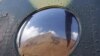 Vladimir Putin Peak, measuring 4,446 meters (14,586 feet) above sea level, is reflected in the window of a helicopter in the Tian Shan mountains.