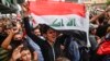 An Iraqi protester chants slogans as he marches with a national flag during an anti-government demonstration in the central holy shrine city of Najaf on October 25, 2019