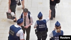 Belgium - Belgian police officers stand guard in central station in Brussels, Belgium June 21, 2017