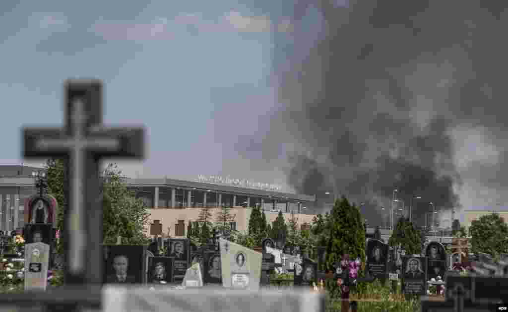 Smoke rises through a cemetery over the Donetsk airport during fighting between Ukrainian forces and pro-Russian separatists.