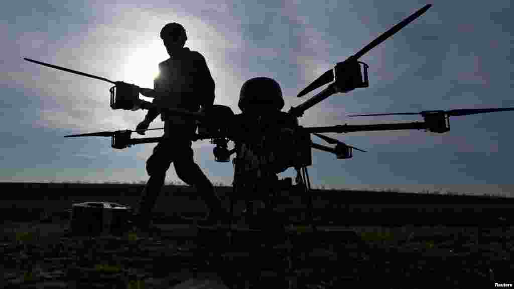 Военнослужащий 422-го полка беспилотных систем идет рядом с тяжелым ударным дроном на полигоне, Запорожская область, 23 марта 2026 года. REUTERS/Stringer