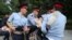 Kazakh police detain a woman during an opposition rally on June 12.
