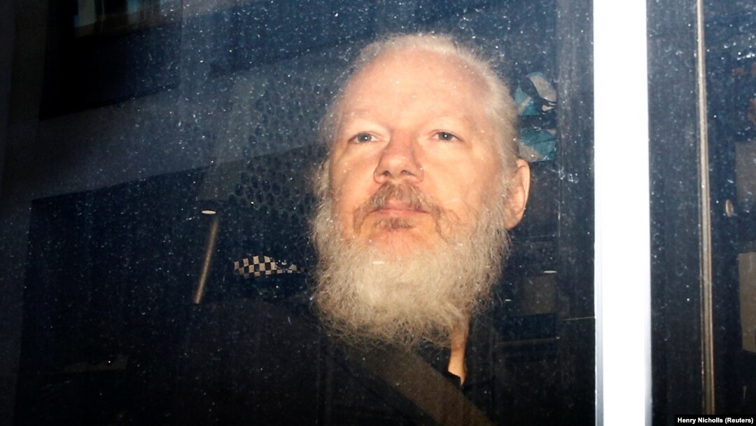 WikiLeaks founder Julian Assange is seen in a police van after his arrest by British police in London on April 11