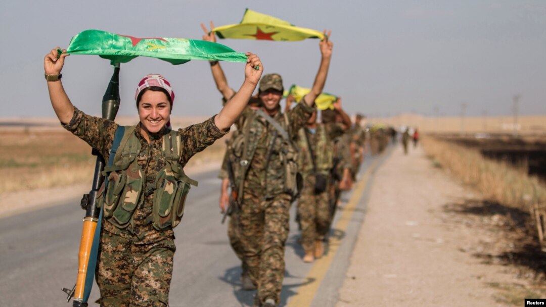 Kurdish fighters celebrate taking control of an area in Syria's Raqqa region last year. 