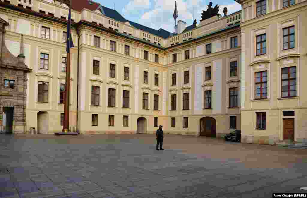 An armed guard photographed in the empty front courtyard of Prague castle.&nbsp;