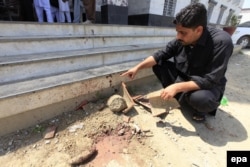 A Pakistani security official surveys the place where student Mashal Khan was killed by a mob.