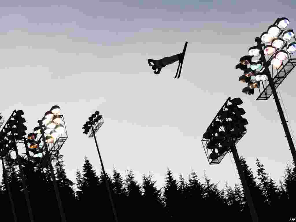 Belarus's Dmitri Dashinski practices his routine ahead of the Men's Freestyle Skiing Aerials qualification. - Photo by Adrian Dennis for AFP