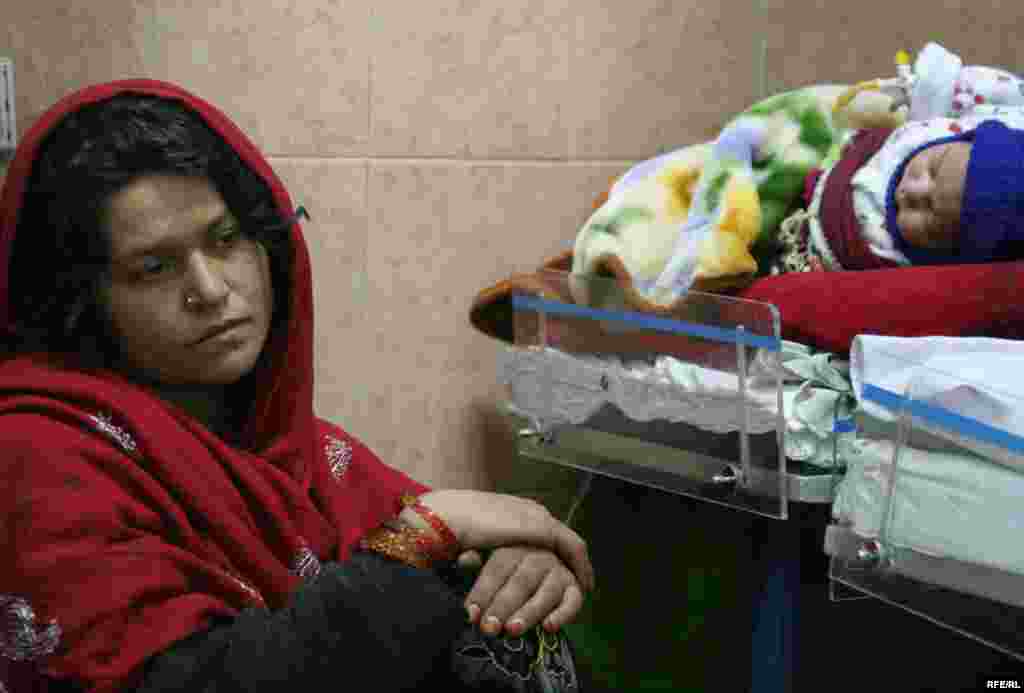 Afghanistan -- Afghan woman waits for her sick child at a hospital in Kabul Afghanistan October 4, 2009 - Afghanistan -- Afghan woman waits for her sick child at a hospital in Kabul Afghanistan October 4, 2009