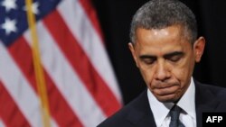 President Barack Obama pauses as he speaks during a memorial service for the victims and relatives of the Sandy Hook Elementary School shooting in Newtown, Connecticut, on December 16. 