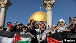 Worshippers chant as they hold Palestinian flags after Friday prayers in Jerusalem's Old City December 8.