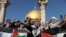 Worshippers chant as they hold Palestinian flags after Friday prayers in Jerusalem's Old City December 8.