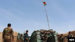 Afghan soldiers take their positions at a check post in Babaji area of restive Helmand Province on April 7.