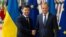 Volodymyr Zelenskiy (left) and Donald Tusk shake hands in Brussels on June 5.
