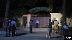 Pakistani news cameramen take footage of the office of the international charity 'Save the Children' sealed by order of Pakistani authorities in Islamabad on June 11.