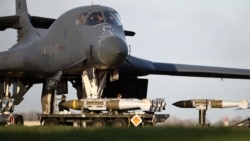 Ground personnel load Joint Direct Attack Munitions (JDAM) into a US Air Force B-1 bomber at RAF Fairford in southwest England -- one of three bases Britain has allowed US forces to use for "certain defensive operations."