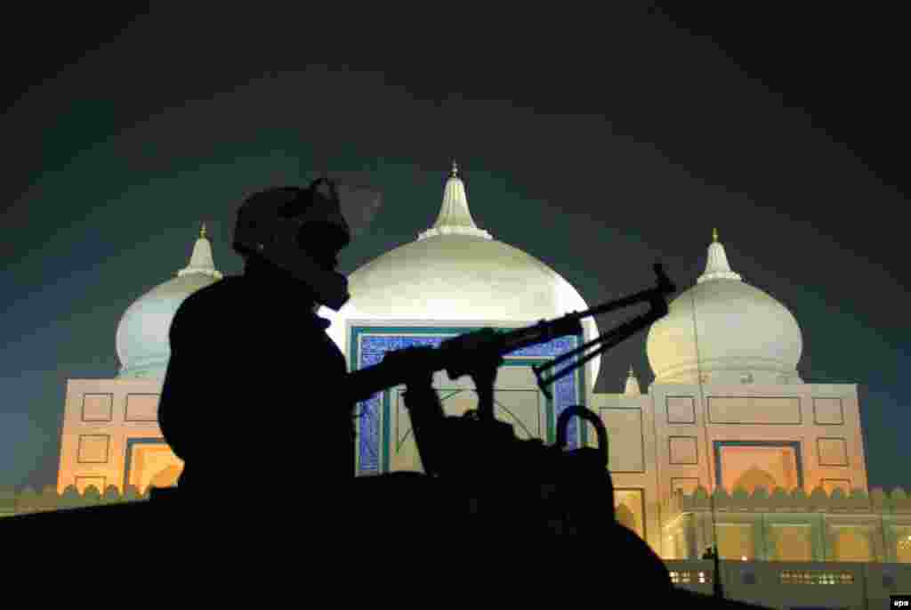 Pakistani police stand guard outside the mausoleum of slain former Prime Minister Benazir Bhutto on the eve of the fifth anniversary of her assassination, in Gari Khuda Buksh. Bhutto was killed in an attack during an election campaign in Rawalpindi on December 27, 2007. (epa/Waqar Hussein)