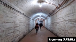 Tourists walk inside a corridor of the Balaklava submarine base in April 2019. The base operates under Russian control as the Museum of the Cold War in Balaklava.