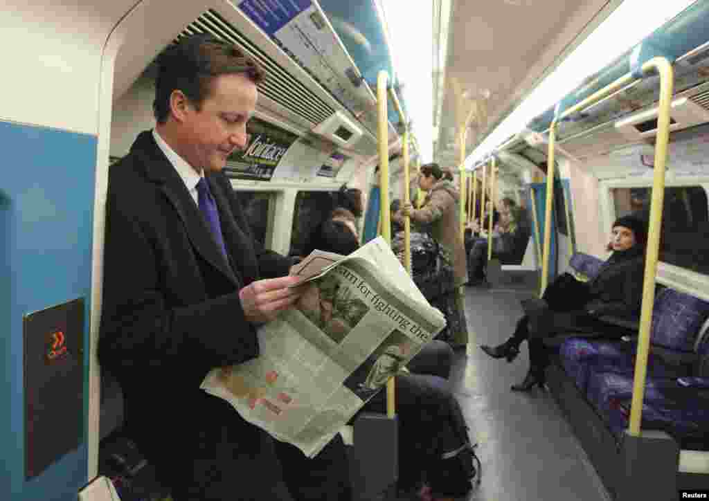 Conservative Party leader David Cameron, who is now prime minister, travels on the Tube after a news conference in 2008.