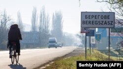 Inscriptions in two languages, Ukrainian and Hungarian, are seen on a road sign of Berehove, a small town in western Ukraine.